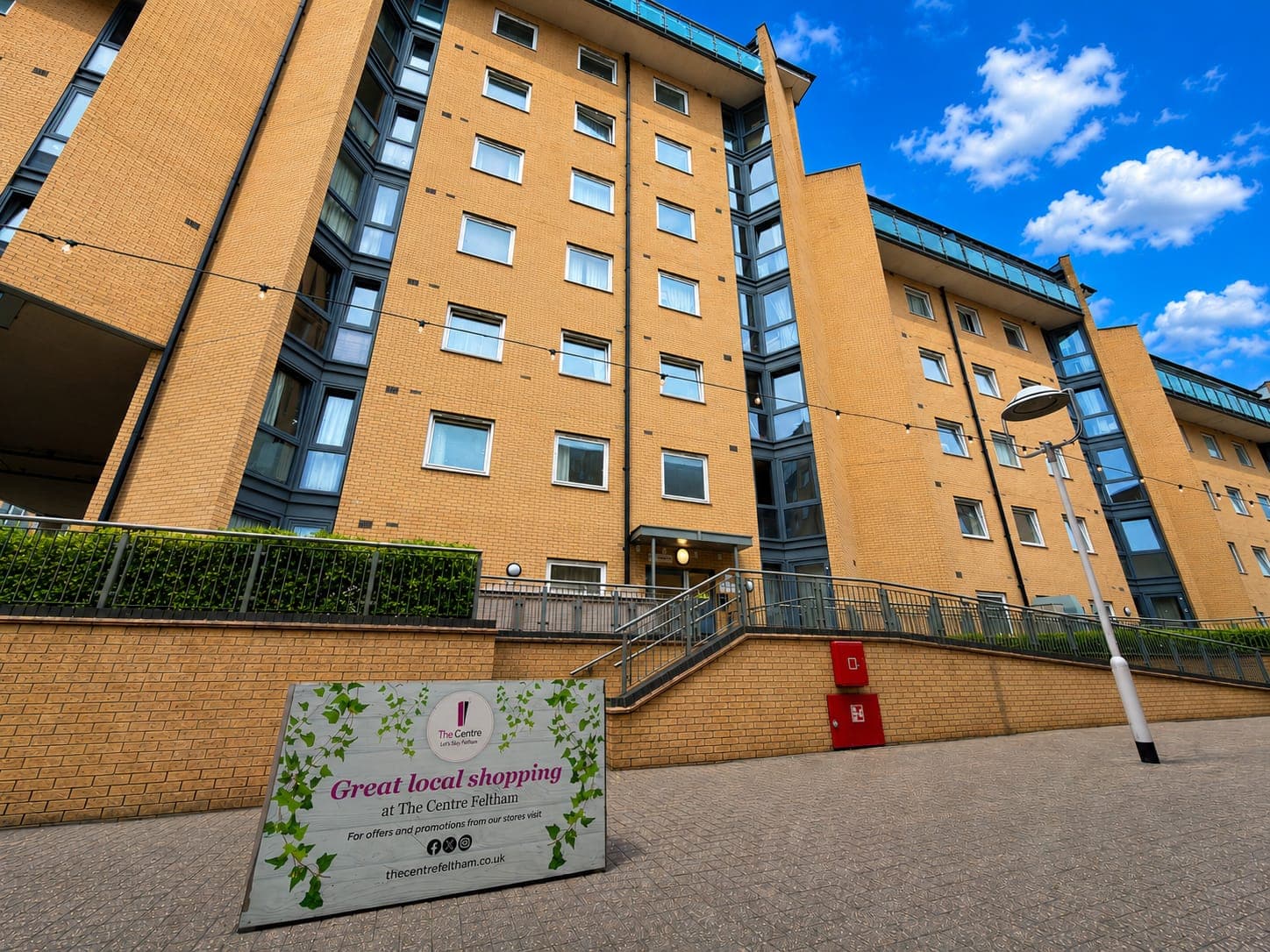 Modern brick-built apartment complex with excellent accessibility. Berberis House features contemporary architecture, secure entry gates, and convenient ground-level access via ramp and stairs.